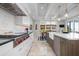 Modern kitchen with stainless steel appliances, marble countertops, and an adjacent dining area at 718 Key Royale Dr, Holmes Beach, FL 34217