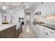 Bright kitchen with stainless steel appliances, marble countertops, and large island with a farmhouse sink at 718 Key Royale Dr, Holmes Beach, FL 34217