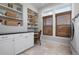 Well-organized laundry room with built-in shelving, cabinets, counter space and natural light at 718 Key Royale Dr, Holmes Beach, FL 34217