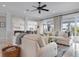 Bright living room with ample seating, stylish decor, large windows, and an open floor plan at 718 Key Royale Dr, Holmes Beach, FL 34217
