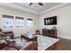 Cozy living room with leather reclining sofa, hardwood floors, and large TV at 718 Key Royale Dr, Holmes Beach, FL 34217