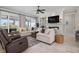 Cozy living room featuring built-in shelving, fireplace, neutral decor and abundant natural light at 718 Key Royale Dr, Holmes Beach, FL 34217