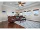 Comfortable living room with a leather sofa, wooden coffee table, and large windows at 718 Key Royale Dr, Holmes Beach, FL 34217