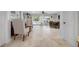 Open-concept living room with stone floors, comfortable seating, and seamless flow to the outdoors at 718 Key Royale Dr, Holmes Beach, FL 34217