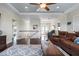 Elegant living room featuring hardwood floors, coffered ceiling, and a comfortable leather reclining sofa at 718 Key Royale Dr, Holmes Beach, FL 34217