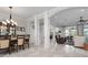 Open-concept living space with dining area, decorative columns, and seamless access to the living room at 718 Key Royale Dr, Holmes Beach, FL 34217