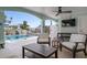 Covered outdoor seating area with views of the pool, providing a perfect space to relax at 718 Key Royale Dr, Holmes Beach, FL 34217
