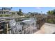 Waterfront patio with tile flooring, rod iron railing, and a white table and chairs overlooking the boat dock at 718 Key Royale Dr, Holmes Beach, FL 34217