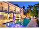 Inviting backyard pool with hot tub and outdoor seating area at 718 Key Royale Dr, Holmes Beach, FL 34217