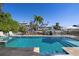 Backyard pool is surrounded by tropical foliage, with outdoor furniture for entertaining and lounging at 718 Key Royale Dr, Holmes Beach, FL 34217