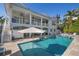 Backyard pool, patio and covered porch create an outdoor living space perfect for relaxing and entertaining at 718 Key Royale Dr, Holmes Beach, FL 34217