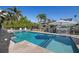 Inviting pool with tanning ledge, outdoor umbrella and lounge chairs for relaxing on sunny days at 718 Key Royale Dr, Holmes Beach, FL 34217