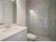 Modern bathroom featuring a glass enclosed shower with gray tile surround and hexagon tile flooring at 8528 Beechlake Ct, Sarasota, FL 34240