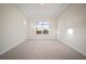 Bright bedroom featuring neutral carpet, trim, paint, and a window with a view at 8528 Beechlake Ct, Sarasota, FL 34240