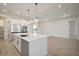 Spacious kitchen with modern stainless steel appliances, a kitchen island, and access to living area at 8528 Beechlake Ct, Sarasota, FL 34240
