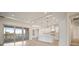 Bright kitchen features white cabinetry, stainless appliances, and a large center island with view to the water at 8528 Beechlake Ct, Sarasota, FL 34240