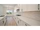 Modern kitchen with white cabinets, stylish backsplash, stainless steel appliances, and bright lighting at 8528 Beechlake Ct, Sarasota, FL 34240