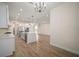 Modern kitchen with stainless steel appliances and an island overlooking the living area at 8528 Beechlake Ct, Sarasota, FL 34240