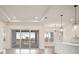Bright open-concept living room with sliding glass doors and an island with pendant lighting at 8528 Beechlake Ct, Sarasota, FL 34240