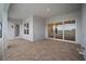 Spacious covered patio featuring tile floors with views of the lake and surrounding properties at 8528 Beechlake Ct, Sarasota, FL 34240