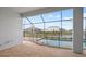 Large screened patio with views of the lake and neighboring houses at 8528 Beechlake Ct, Sarasota, FL 34240