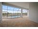 Covered patio featuring tile floors, views of the pool and a beautiful lake at 8528 Beechlake Ct, Sarasota, FL 34240