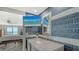 Beautiful bathroom with blue textured tile, marble countertop sink, and flat screen television at 101 S Gulfstream Ave # 16J, Sarasota, FL 34236