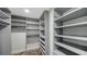 Spacious closet with custom shelving and storage with herringbone-patterned flooring at 101 S Gulfstream Ave # 16J, Sarasota, FL 34236