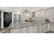 Bright kitchen featuring stainless steel appliances and a large countertop island with seating at 101 S Gulfstream Ave # 16J, Sarasota, FL 34236