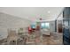 Bright living area connected to an open kitchen, featuring herringbone floors and modern finishes at 101 S Gulfstream Ave # 16J, Sarasota, FL 34236