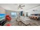 Comfortable living room with views of the water, light stone accent wall, and open flow to the bedroom at 101 S Gulfstream Ave # 16J, Sarasota, FL 34236