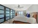 Bright bedroom with modern closet, wood-style flooring, and partial water views at 101 S Gulfstream Ave # 16J, Sarasota, FL 34236