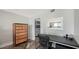 Stylish office with custom dresser, decorative mirror, and herringbone floors leading to the ensuite bathroom at 101 S Gulfstream Ave # 16J, Sarasota, FL 34236