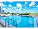 Community pool with a clear blue sky and plenty of space for lounging at 101 S Gulfstream Ave # 16J, Sarasota, FL 34236