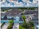 Aerial view of a residential neighborhood with blue house and well-maintained landscaping at 11728 Meadowgate Pl, Bradenton, FL 34211
