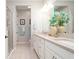 Well-lit bathroom with a double vanity, granite countertops, tile flooring, and a glass shower enclosure at 11728 Meadowgate Pl, Bradenton, FL 34211