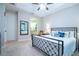 Bedroom featuring plush carpeting, ceiling fan, neutral paint, and a modern iron bed frame at 11728 Meadowgate Pl, Bradenton, FL 34211