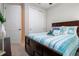 Bedroom with a coastal theme featuring a striped comforter, dark wood furniture, and ample closet space at 11728 Meadowgate Pl, Bradenton, FL 34211