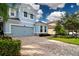 Charming two-story home features a paved driveway, manicured lawn, and lovely curb appeal at 11728 Meadowgate Pl, Bradenton, FL 34211
