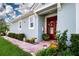 Charming home featuring a welcoming front door, brick walkway, and beautifully landscaped yard at 11728 Meadowgate Pl, Bradenton, FL 34211