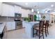 Modern kitchen featuring white cabinets, stainless steel appliances, and an island with seating at 11728 Meadowgate Pl, Bradenton, FL 34211