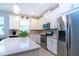Modern kitchen featuring stainless steel appliances, white cabinets, quartz countertops, and backsplash at 11728 Meadowgate Pl, Bradenton, FL 34211