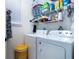 Functional laundry room with a side-by-side washer and dryer, wire shelving, and a bright window at 11728 Meadowgate Pl, Bradenton, FL 34211