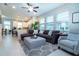 Comfortable living room with a large sectional sofa, open to kitchen and dining areas at 11728 Meadowgate Pl, Bradenton, FL 34211