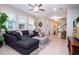 Well-lit living room with comfortable seating, large windows, and tile flooring at 11728 Meadowgate Pl, Bradenton, FL 34211
