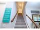 Carpeted staircase with wooden handrails leads to the upper level at 11728 Meadowgate Pl, Bradenton, FL 34211
