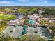Aerial image of a golf and tennis club featuring well-maintained tennis courts, a pool, clubhouse, and beautifully landscaped grounds at 124 Ventana Way, Venice, FL 34292