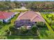 Aerial view of a well-maintained home with a tile roof, screened-in lanai, mature landscaping, and spacious backyard at 124 Ventana Way, Venice, FL 34292