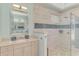 Spa-like bathroom with double vanity, tiled walls and glass enclosed shower at 124 Ventana Way, Venice, FL 34292