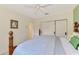 Bedroom featuring a patterned bedspread, ceiling fan, and view to the en-suite bathroom and closet at 124 Ventana Way, Venice, FL 34292